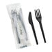 A set of black compostable heavy weight knife and fork, with one set wrapped in packaging labeled 'Compostable.'