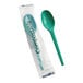 A green compostable heavy weight spoon, with one spoon individually wrapped in plastic packaging labeled 'Compostable.'