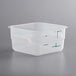 A square translucent plastic container with a lid and green writing on it.