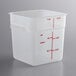 A white translucent square plastic food storage container with red measurements on the side.