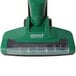 A green Bissell upright / handheld vacuum cleaner with a handle.