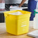 A yellow Noble King-Pail 10 quart cleaning pail filled with soapy water.