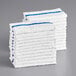 A stack of white towels with blue stripes.