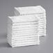 A stack of Choice white cotton textured terry bar towels.