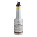 A close-up of a Monin Pineapple Fruit Puree bottle with a black lid.