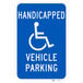 A blue aluminum sign with white text that says "Handicapped Vehicle Parking"