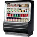 A black Turbo Air refrigerated display case with drinks and beverages.