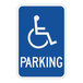 A blue sign with white text reading "Handicap Parking" and a white wheelchair symbol.