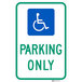 A blue aluminum parking lot sign with white wheelchair symbol and text that reads "Handicapped Parking Only"