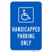 A blue sign with white text that says "Handicapped Parking Only" and a white symbol of a person in a wheelchair.