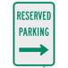 A green parking sign with white text and a right arrow.