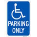 A blue sign with a white wheelchair symbol and text that says "Handicap Parking Only"