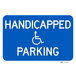 A blue aluminum parking lot sign with white text that says "Handicapped Parking"