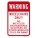 A red and white rectangular aluminum sign that says "Warning / Wheelchairs Only!" in white text.