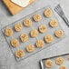 A cookie on a Baker's Mark stainless steel footed wire cooling rack.