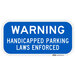 A blue sign with white letters that says "Warning / Handicapped Parking / Laws Enforced" in white.