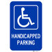 A blue Lavex aluminum parking sign with white letters and a symbol of a person in a wheelchair.