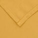 A close up of a yellow hemmed square Intedge table cover.