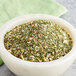A bowl of Backyard Pro All-Purpose Seasoning Blend on a table.
