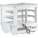 A white refrigerated countertop bakery display case with glass doors.