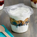 A Dart plastic snack cup with yogurt and granola with a flat lid.