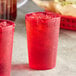 Two red Choice plastic tumblers filled with ice and red liquid.