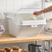 A large white ingredient bin with a flip lid, label, and scoop, designed for storing bulk baking ingredients.