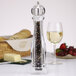 A Chef Specialties Ultima acrylic pepper mill with black and white peppercorns in it.