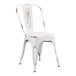 A white metal Lancaster Table & Seating outdoor cafe chair with a rustic finish.