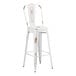 A white metal Lancaster Table & Seating outdoor cafe barstool with a wooden seat.