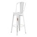 A Lancaster Table & Seating white metal outdoor cafe barstool with a wooden seat and backrest.