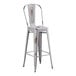 A white metal outdoor cafe barstool with a metal seat.