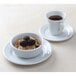 A Tuxton bright white china bowl filled with cereal and blackberries on a white background.
