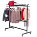 A black Correll hanging folding chair / coat truck with clothes on it.