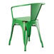 A Lancaster Table & Seating distressed jade green metal outdoor arm chair with a black back.