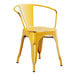 A Lancaster Table & Seating yellow metal outdoor arm chair with arms.
