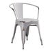 A white metal outdoor arm chair with a white seat and back.