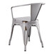 A Lancaster Table & Seating distressed nickel gray metal outdoor arm chair.