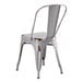 A Lancaster Table & Seating distressed nickel gray metal outdoor cafe chair with a backrest.