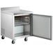 An Avantco stainless steel worktop refrigerator with a door open.