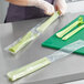 A person holding celery in a Choice clear plastic bag.