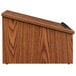 A wooden tabletop lectern with a black handle.