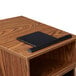 A black tablet on a medium oak tabletop lectern.