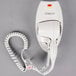 A white Conair wall mount hair dryer with a cord.