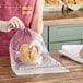 A clear gusseted plastic bread bag being used to package a loaf of bread.