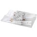 A clear plastic TamperSafe bag with perforated tear strips over three white plastic bags with electrical plugs inside.