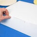 A hand opening a white customizable cake box.