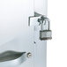 The metal door on a Traulsen Correctional Roll In Refrigerator with a lock.