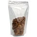 A Choice clear nylon stand-up pouch with a hanging hole filled with almonds.