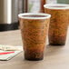 Two Dart Fusion Escape foam cups with different designs on a table.
